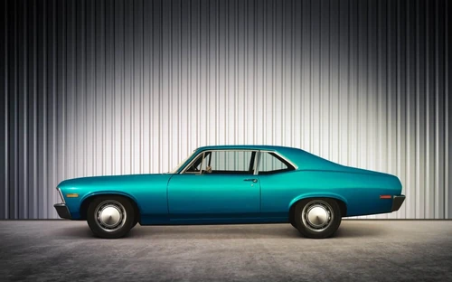 A vintage teal car in storage
