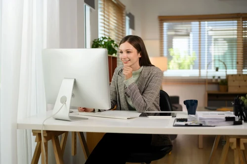 A young businessperson working at a home office.